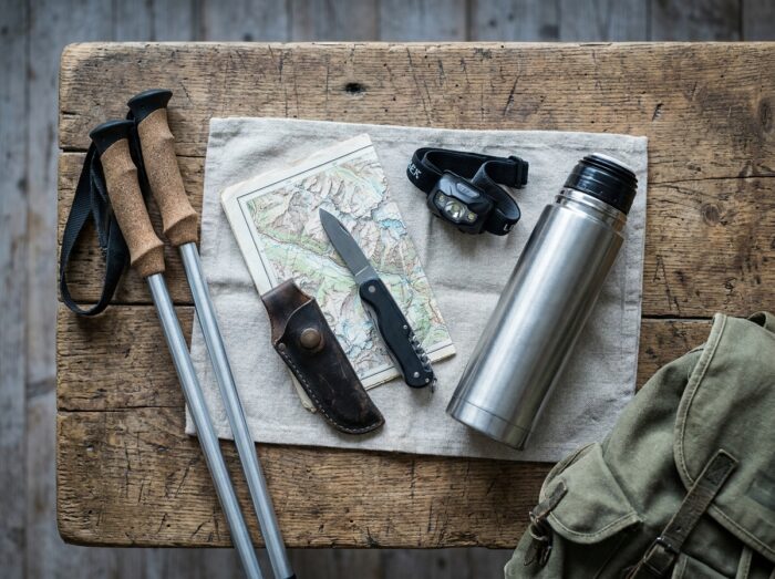 Selection of gifts for hikers arranged in a flat lay on a rustic wooden table